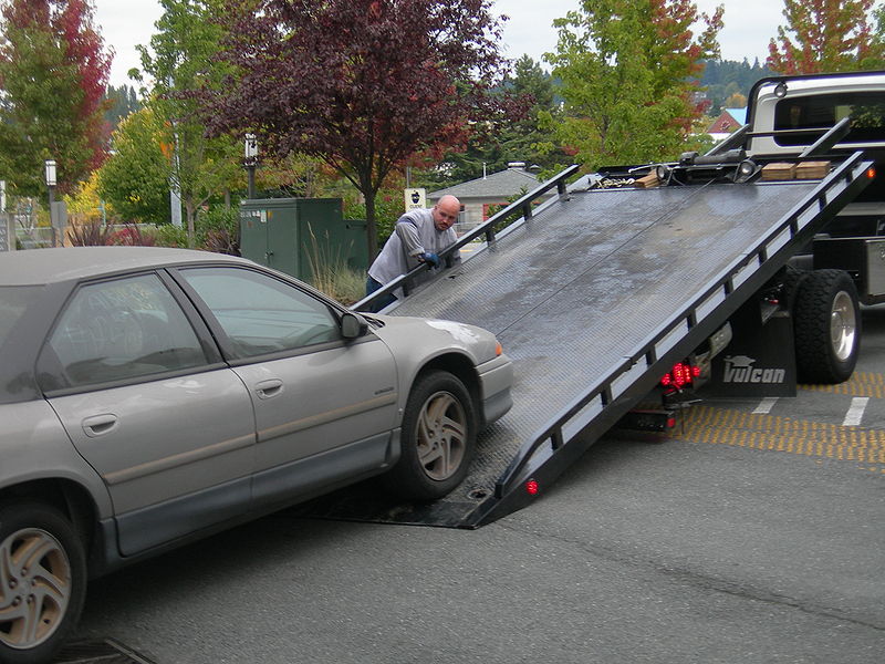 flat bed tow truck with fall trees