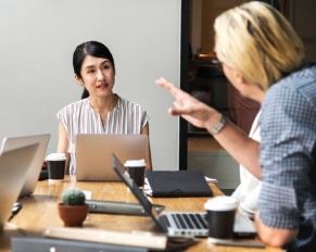 women listening with laptop