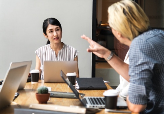 women listening with laptop