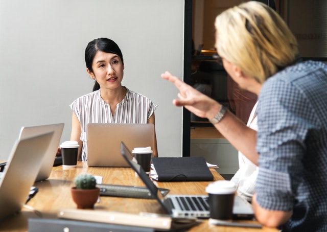 women listening with laptop