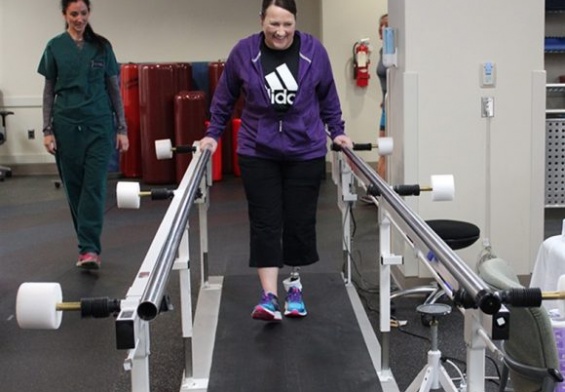 patient on treadmill working with physical therapist