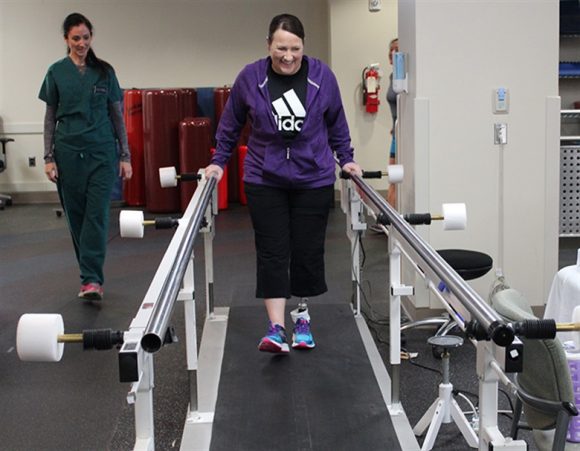 patient on treadmill working with physical therapist