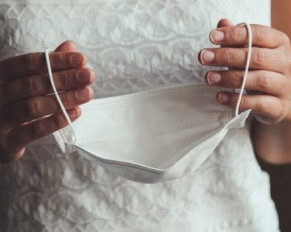 bride holding face mask