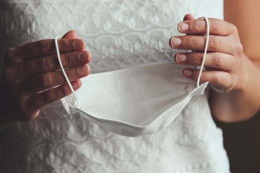 bride holding face mask