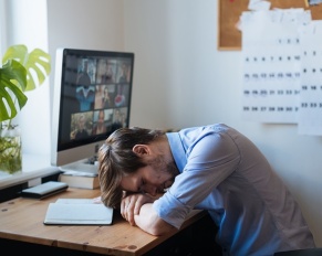 exhausted man working from home