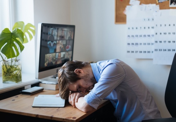 exhausted man working from home