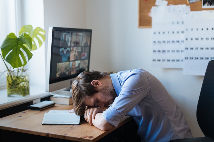 exhausted man working from home