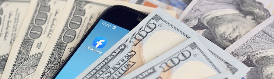 smartphone with Facebook app and hundred dollar bills