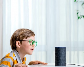 child using Amazon Alexa; smart in home entertainment system