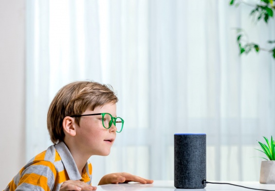 child using Amazon Alexa; smart in home entertainment system