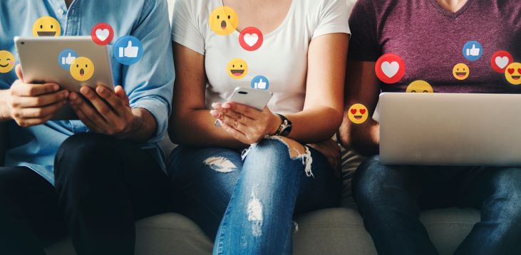 people sitting on couch using social media applications