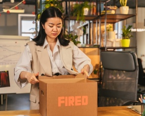 woman packing up her desk after being wrongfully terminated from her job