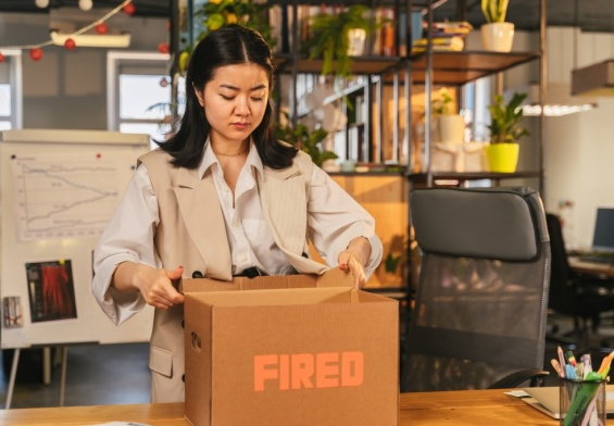 woman packing up her desk after being wrongfully terminated from her job